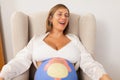 Portrait of a happy pregnant woman laughing with her painted belly Royalty Free Stock Photo