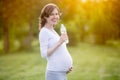 Portrait of happy pregnant woman posing with bottle of water in Royalty Free Stock Photo