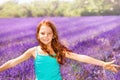 Happy red-headed girl having fun in lavender field