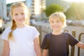 Portrait of a happy preteens girl and boy on a city street during a summer sunset. Friends are walking together