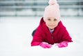 Portrait of happy pretty little girl plainf with snow in winter Royalty Free Stock Photo