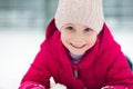 Portrait of happy pretty little girl plainf with snow in winter Royalty Free Stock Photo