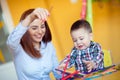 Portrait of happy pretty mother with her toddler son drawing Royalty Free Stock Photo