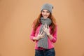 Portrait of a happy pretty redhead girl dressed in winter hat Royalty Free Stock Photo