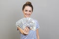 Woman holding out dollar bills at camera, offering lots of money, earning concept. Royalty Free Stock Photo