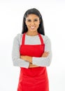 Portrait of a happy proud beautiful latin woman wearing a red apron learning to cook making thumb up gesture in cooking classes