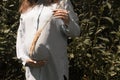 Portrait of a happy and proud pregnant woman by the river in the city. Woman in the light blue shirt Royalty Free Stock Photo