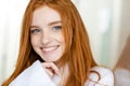 Portrait of a happy redhead woman in bathrobe Royalty Free Stock Photo