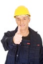 Portrait of happy repairman showing thumbs up