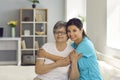 Happy senior woman together with her home care nurse or caregiver smiling at camera Royalty Free Stock Photo