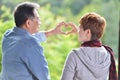 Portrait of happy romantic senior couple making heart shape with hands Royalty Free Stock Photo