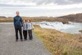 Portrait of happy running kids, boy brothers, near smaller waterfall around Gullfoss, Iceland