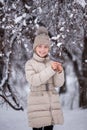 Portrait Of Happy Russian Little Girl In On Background Of Melting Snow In Park In Spring Close Up. Child Walking Outdoors