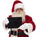 Portrait of happy saint nick presenting blank screen