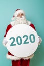 Santa holding cardboard circle with numbers 2020