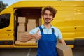 Portrait of happy satisfied courier showing thumbsup like gesture