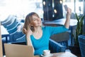 Portrait of happy satisfied funny young blonde woman in blue shirt holding mobile smart phone, making selfie or video call with Royalty Free Stock Photo