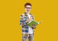 Portrait of happy school child in glasses holding pencil and notebook and smiling Royalty Free Stock Photo