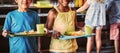 Happy school children holding food tray in canteen Royalty Free Stock Photo