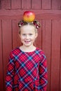 Portrait of a happy school girl with red apple on head. Farewell Bell. day of knowledge. beginning of the school year Royalty Free Stock Photo