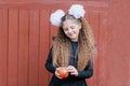 Portrait of a happy school girl standing with red apple on head. Farewell Bell. day of knowledge Royalty Free Stock Photo