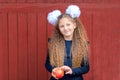 Portrait of a happy school girl standing with red apple on head. Farewell Bell. day of knowledge Royalty Free Stock Photo