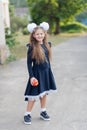 Portrait of a happy school girl standing with red apple on head. Farewell Bell. day of knowledge Royalty Free Stock Photo