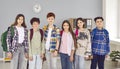 Portrait of a happy school students children looking at camera and smiling standing in classroom Royalty Free Stock Photo