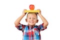 Portrait of happy schoolboy with book and apple on his head isolated white background. Education Royalty Free Stock Photo