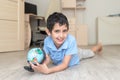 Portrait of a happy schoolboy studying a globe in the room Royalty Free Stock Photo