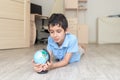 Portrait of a happy schoolboy studying a globe in the room Royalty Free Stock Photo