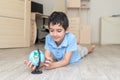 Portrait of a happy schoolboy studying a globe in the room Royalty Free Stock Photo