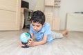 Portrait of a happy schoolboy studying a globe in the room Royalty Free Stock Photo