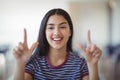 Portrait of happy schoolgirl gesturing in classroom