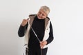 Portrait of happy senior adult elderly woman measuring waist with measuring tape