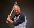 Portrait of a happy senior adult man with a baseball bat