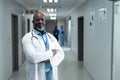 Portrait of happy senior african american male doctor in hospital corridor, copy space Royalty Free Stock Photo