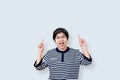 Portrait of happy senior asian woman gesture or pointing hand and finger up and looking at camera on isolated background Royalty Free Stock Photo