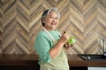 Portrait of happy Senior Asian woman patient eating fresh and clean vegetarian salad in the kitchen at home, cooking healthy food Royalty Free Stock Photo