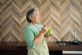 Portrait of happy Senior Asian woman patient eating fresh and clean vegetarian salad in the kitchen at home, cooking healthy food Royalty Free Stock Photo