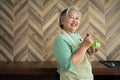 Portrait of happy Senior Asian woman patient eating fresh and clean vegetarian salad in the kitchen at home, cooking healthy food Royalty Free Stock Photo