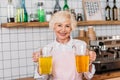 portrait of happy senior cafe worker holding glass jars of lemonade Royalty Free Stock Photo