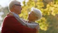 Portrait of happy senior Caucasian couple hugging in the park looking at each other elderly people wellbeing concept Royalty Free Stock Photo