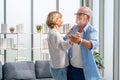 Portrait of happy senior couple dancing in living room, Elderly woman and a man dancing, Happy family concepts Royalty Free Stock Photo