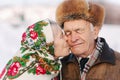 Portrait of happy senior couple. Elderly woman kiss her husband in weighty. old couple walking in the park in winter