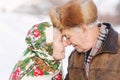 Portrait of happy senior couple. Elderly woman kiss her husband in weighty. old couple walkink in the park in winter