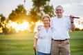 Portrait of happy senior couple enjoying active lifestyle playing golf Royalty Free Stock Photo