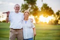 Portrait of happy senior couple enjoying active lifestyle playing golf Royalty Free Stock Photo