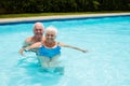 Portrait of happy senior couple in the pool Royalty Free Stock Photo