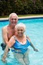 Portrait of happy senior couple in the pool Royalty Free Stock Photo